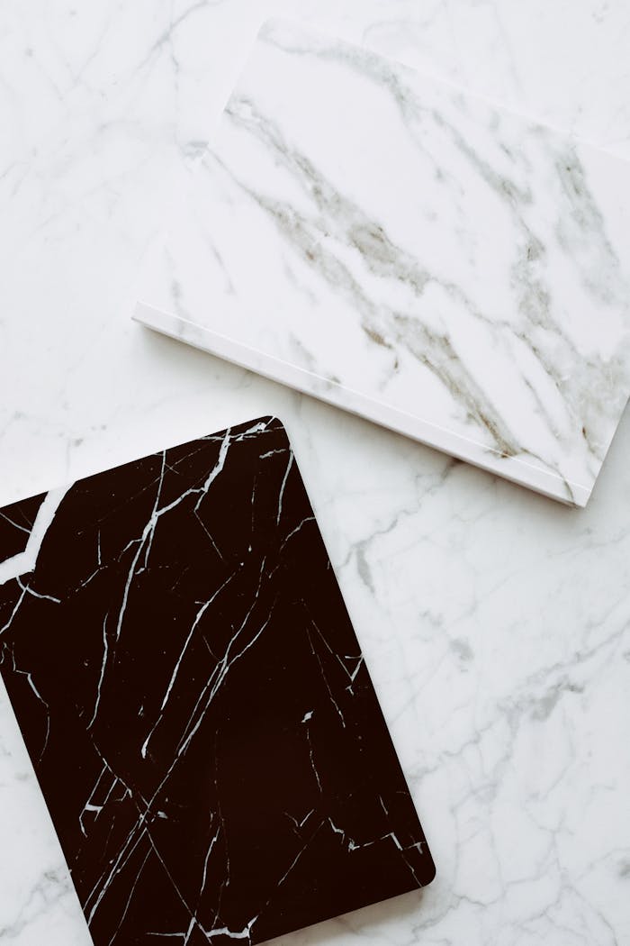 brand-03 High-quality close-up of contrasting white and black marble tiles on a smooth surface.